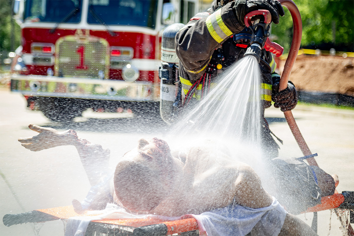 Fire Fighter hosing down Tommanikin